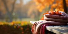 Cozy Knitted Scarf On An Outdoor Bench, With Colorful Autumn Leaves