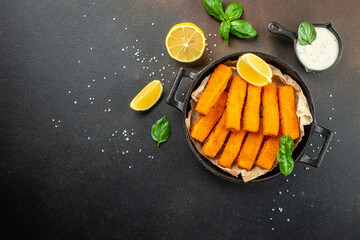 Canvas Print - Fish fingers sticks on a dark background. banner, menu, recipe place for text, top view