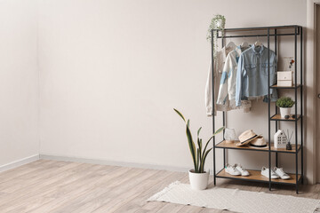 Wall Mural - Shelving unit with clothes and accessories in modern hall