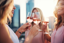 Group Of Happy Rich And Stylish Woman Friends Clinking With Glasses Of Wine, Celebrating Holiday In Dubai With Skyline And Skyscrapers In The Background