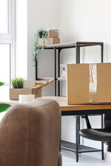 Poster - Interior of light office with cardboard boxes on moving day