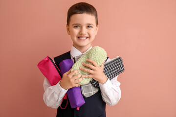 Canvas Print - Cute little schoolboy with pencil cases on color background