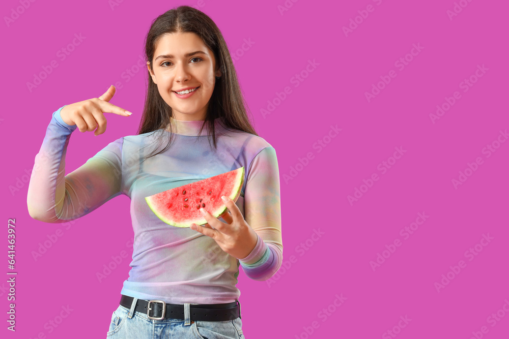 Young woman pointing at fresh watermelon on purple background