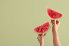 Female Hands With Slices Of Ripe Watermelon On Green Background