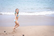 © magda91fotolia - A little girl in a swimsuit runs on a sandy beach in Georgia and plays with the waves