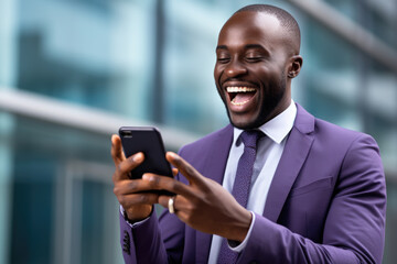 Wall Mural - Man wearing purple suit is captured smiling as he looks at his cell phone. This image can be used to depict modern communication, technology, and professional attire.