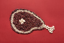 Conceptual Photo Of Chicken Leg Made Up Of Red And White Beans On Red Background  