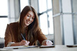 © TrueFrame Collective - Cheerful student doing homework