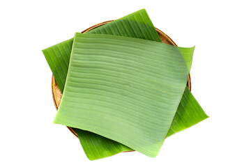 Banana leaves on bamboo weave plate on white background.