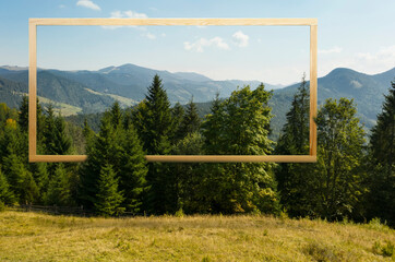 Wooden frame and beautiful mountains under blue sky with clouds