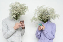 Couple with floral heads using phones