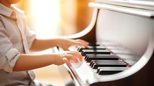 A Cute Kid Boy Pianist Is Sitting On The Piano Beside The Colorful Flower Garden. Natural Light Shines Orange From The Morning Sun Or Sunset. Music Training And Development In Children.