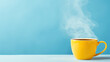 © red_orange_stock - Yellow hot cup of coffee with smoke on pastel blue background, copy space
