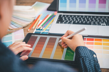 Fototapete - Graphic designer architects who work with laptops and color comparison tables for design work..