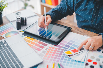 Fototapete - Graphic designer architects who work with laptops and color comparison tables for design work..