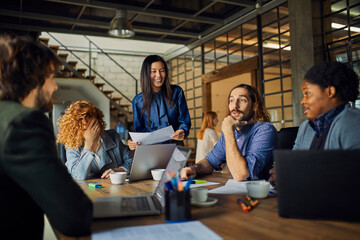 Young and diverse group of coworkers working on a project and having a meeting in a startup company office