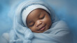 © tashechka - Sleeping african american baby on soft blue background