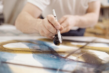 Closeup Of Man Using Airbrush While Painting