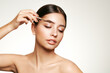 Beautiful woman puts mascara on her eyebrows. Eyelash extensions. Healthy clean fresh skin natural make up beauty eyes