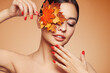 © Oleg Gekman - Portrait of beautiful young woman with autumn leafs. Healthy clean fresh skin natural make up beauty eyes and red nails