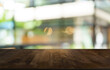 © Charlie's - Mock up for space. Empty dark wooden table in front of abstract blurred bokeh background of restaurant . can be used for display or montage your product