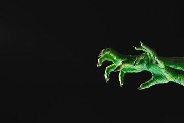 Poster - Green monster hands with black nails reaching on black background