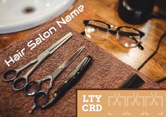 Wall Mural - Composite of hair salon loyalty card text over scissors and razor in hairdresser's salon