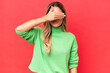© luismolinero - Young Uruguayan woman isolated on red background covering eyes by hands. Do not want to see something