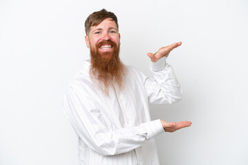 Wall Mural - Redhead man with long beard isolated on white background holding copyspace to insert an ad