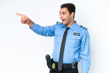 Wall Mural - Young police caucasian man isolated on white background pointing away