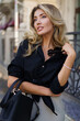 © Svetlana Sokolova - Outdoor portrait of beautiful elegant blond woman with perfect wavy hairs  holding luxury hand bag. Fashion acsessories , black blouse. Autumn look.