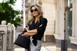 © Svetlana Sokolova - Outdoor portrait of beautiful  blond woman  in sunglasses with perfect wavy hairs  holding luxury hand bag. Fashion acsessories , Casual outfit.