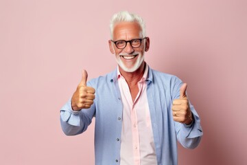 Wall Mural - Lifestyle portrait photography of a satisfied mature man raising both thumbs up against a pastel or soft colors background. With generative AI technology