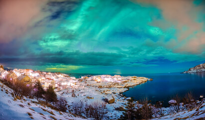 Wall Mural - aurora borealis glowing over scandinavian village on coastline in winter at lofoten islands