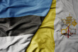 big waving national colorful flag of estonia and national flag of vatican city .