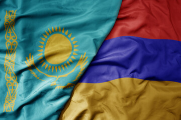 big waving national colorful flag of kazakhstan and national flag of armenia .