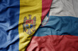 big waving national colorful flag of moldova and national flag of slovenia .