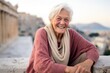 Medium shot portrait photography of a grinning old woman striking a thinking pose dressed in a comfy fleece pullover at the acropolis in athens greece. With generative AI technology