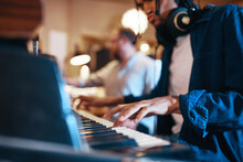 Young Musician Playing Keyboards During A Studio Session