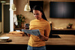 © Flamingo Images - Woman reading a newspaper at home
