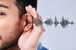 © LuneVA/peopleimages.com - Ear, listening and sound waves with a hand on a studio background for communication, gossip or attention. Closeup, digital and a person for hearing an audio, speaker or frequency for conversation