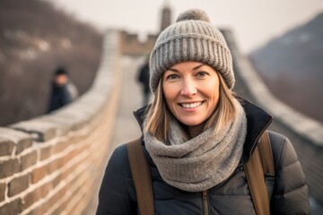 Poster - Lifestyle portrait photography of a merry girl in her 40s wearing a warm wool beanie at the great wall of china in beijing china. With generative AI technology