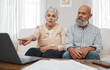 © Wesley/peopleimages.com - Budget, finance and senior couple with laptop planning financial investments, mortgage or tax papers. Elderly woman apeaking of bills, debt and pension fund on bank statement with an old man at home