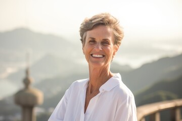 Poster - Photography in the style of pensive portraiture of a happy mature woman wearing a classic white shirt at the christ the redeemer in rio de janeiro brazil. With generative AI technology