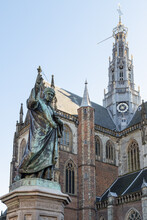 Statue of Laurens Janszoon Coster with in the background the Grote Kerk - St. Bavokerk, in the city of Haarlem.