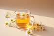 glass cup of camomile tea on a pastel background