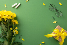 Express Teacher’s Day Wishes Uniquely. Top-view Photo Showcases Chalk, Glasses, Yellow Chrysanthemum Flowers And Gift Box On Chalkboard Isolated Background With Copy-space For Ads Or Text Placement