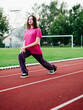 © mark_gusev - Young teenager girl doing stretching exercises on a running track. Selective focus. The model is slim body type. Light and airy look. Get ready for sport concept. Outdoor activity and lifestyle.