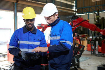 Wall Mural - factory workers or engineer using tablet for work in robot factory