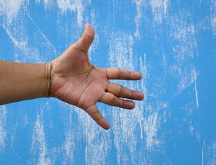 Man's hand to symbol mean the warning on a blue with white painted on a cement wall with clipping path, abstract sign concept. 